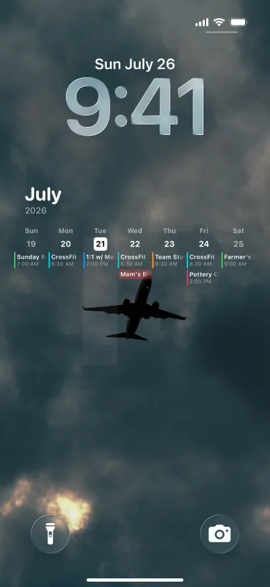 iPhone lock screen: the week's events over a photo of a plane in dramatic clouds