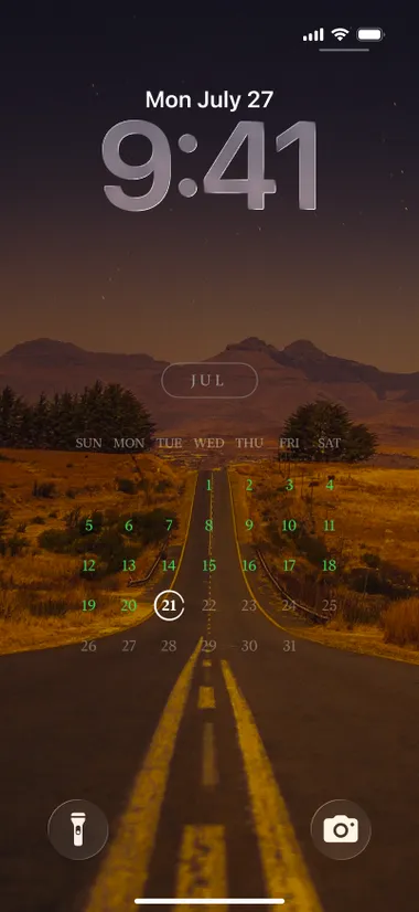 iPhone lock screen: the poster month view over a photo of a desert highway