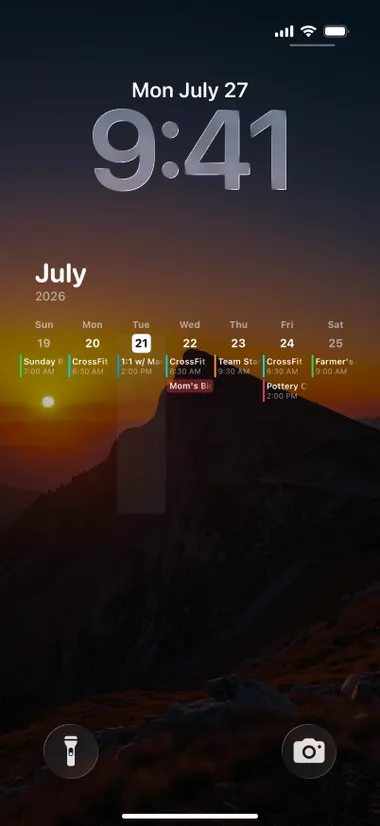 iPhone lock screen: the week's events over a photo of a mountain at sunset